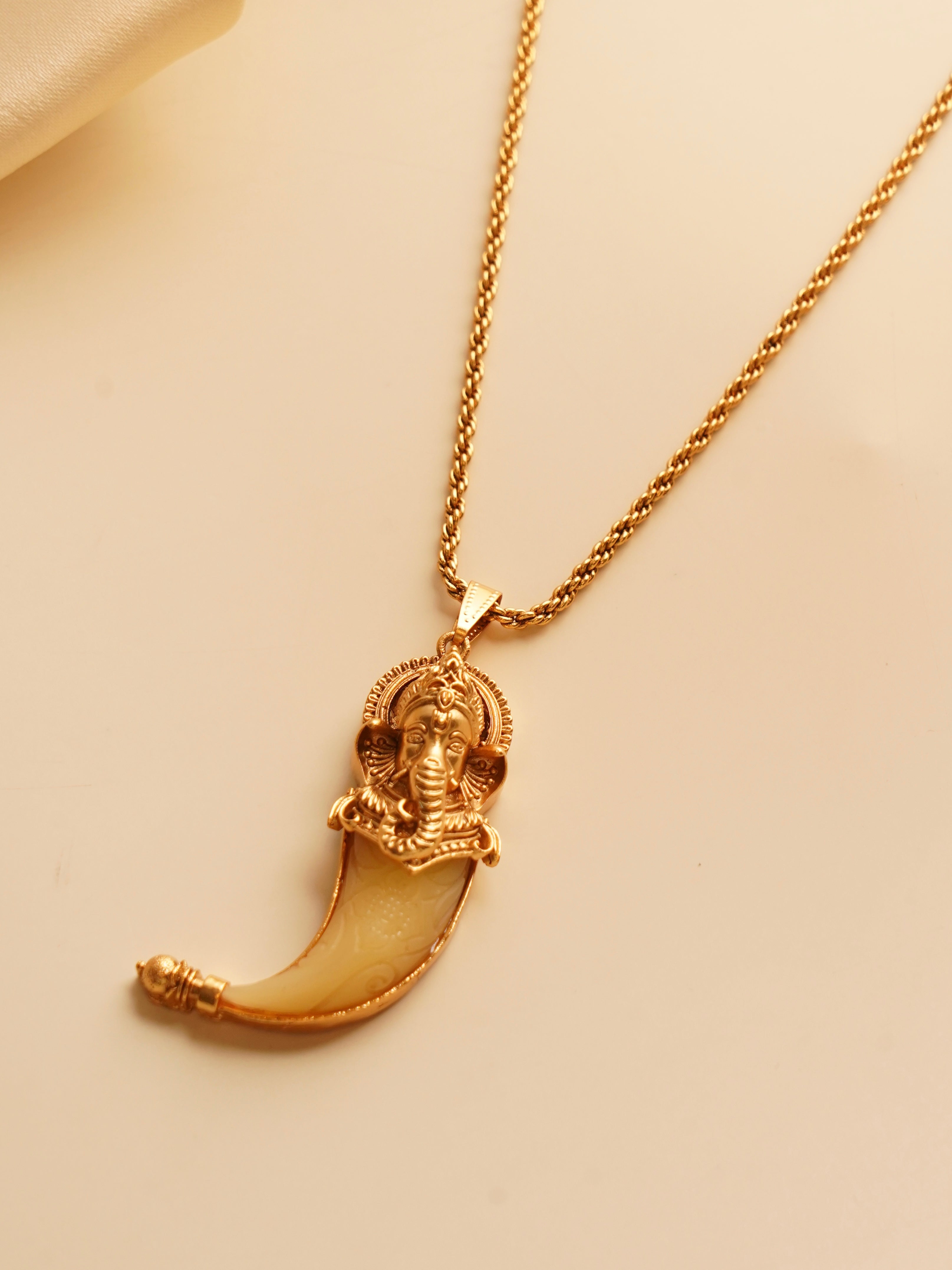 Ganesha pendant necklace in gold finish with detailed carving on copper-brass base
